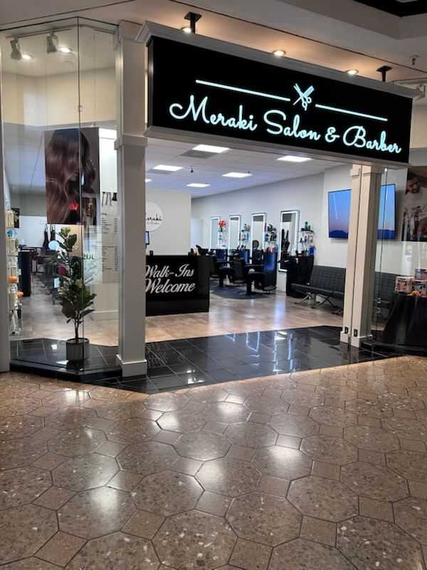 Meraki Salon & Barber entrance with modern interior and "Walk-Ins Welcome" sign.